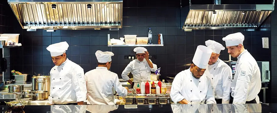 chefs cooking in kitchen
